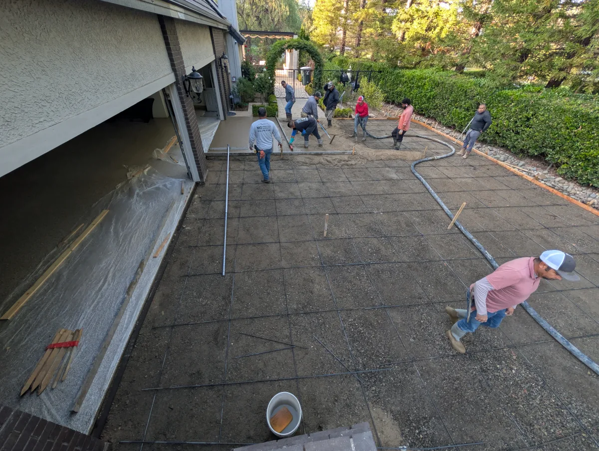 MG Concrete crew placing concrete and working around reinforcement at the Granite Bay driveway