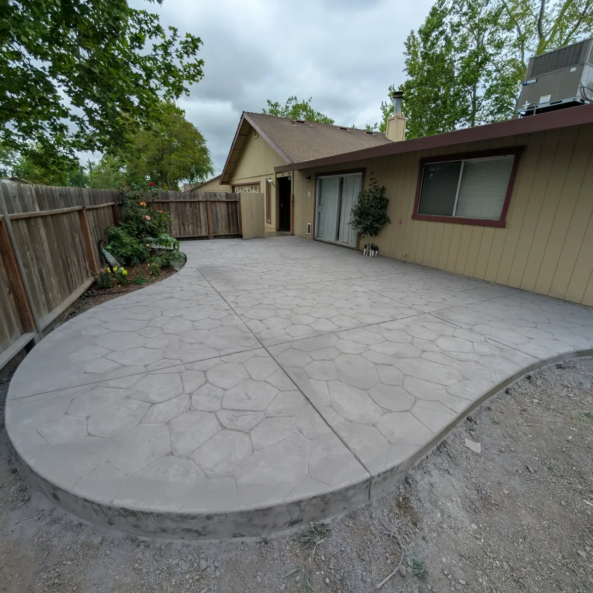 Completed concrete backyard patio by MG Concrete